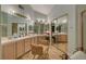 Bright and spacious bathroom with dual sinks, ample vanity space, and mirrored closet doors at 7613 Hackensack Ct, Las Vegas, NV 89128