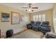 This bedroom offers three comfortable leather reclining chairs and a ceiling fan with warm lighting at 7613 Hackensack Ct, Las Vegas, NV 89128