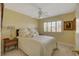 Cozy bedroom with a comfortable bed, ceiling fan, and shuttered window with warm natural lighting at 7613 Hackensack Ct, Las Vegas, NV 89128