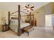 Spacious bedroom featuring a four-poster bed, ceiling fan, and ample natural light at 7613 Hackensack Ct, Las Vegas, NV 89128