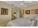 This bedroom has a ceiling fan, neutral carpet, a mirrored closet, and warm natural lighting at 7613 Hackensack Ct, Las Vegas, NV 89128