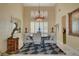 Formal dining area featuring a decorative chandelier, a stylish rug, and ample natural light at 7613 Hackensack Ct, Las Vegas, NV 89128