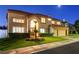 Elegant two-story home featuring a lush front lawn and a spacious three-car garage at 7613 Hackensack Ct, Las Vegas, NV 89128