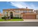 Elegant two-story home featuring a tiled roof and an attached two-car garage at 7613 Hackensack Ct, Las Vegas, NV 89128