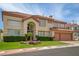 Beautiful two-story home with a well-manicured lawn and desert-friendly landscaping at 7613 Hackensack Ct, Las Vegas, NV 89128