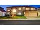 Stunning two-story home with a well-manicured lawn and three-car garage at 7613 Hackensack Ct, Las Vegas, NV 89128