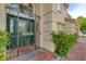 Charming front entrance with a decorative wrought iron gate and lush greenery at 7613 Hackensack Ct, Las Vegas, NV 89128