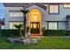 Inviting front entrance featuring an arched entryway, lush greenery, and a secure iron gate at 7613 Hackensack Ct, Las Vegas, NV 89128