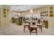 Bright kitchen features a marble floor, island with chairs, and white and green cabinets at 7613 Hackensack Ct, Las Vegas, NV 89128