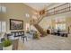 Bright living room with marble floors, a staircase, and modern decor creates an inviting space at 7613 Hackensack Ct, Las Vegas, NV 89128