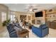 Cozy living room featuring a fireplace, built-in shelves, and comfortable blue seating at 7613 Hackensack Ct, Las Vegas, NV 89128