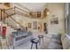 Elegant living room showcasing staircase, stylish decor, and marble floors at 7613 Hackensack Ct, Las Vegas, NV 89128
