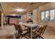 Inviting covered patio with a dining table, comfortable seating, and views of the serene, well-maintained backyard at 7613 Hackensack Ct, Las Vegas, NV 89128