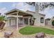 Charming backyard with covered patio, lush turf, and convenient shed for storage at 8121 Heavenly Star Cir, Las Vegas, NV 89128