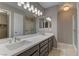 Elegant bathroom featuring double sinks, a long vanity, and modern lighting fixtures at 8121 Heavenly Star Cir, Las Vegas, NV 89128