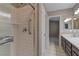 Updated bathroom with a tiled shower, glass door, and modern vanity with double sinks at 8121 Heavenly Star Cir, Las Vegas, NV 89128