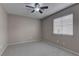 Neutral carpeted bedroom featuring a modern ceiling fan and bright natural light at 8121 Heavenly Star Cir, Las Vegas, NV 89128