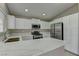 Modern kitchen featuring white cabinets, stainless steel appliances, and quartz countertops at 8121 Heavenly Star Cir, Las Vegas, NV 89128