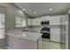 Updated kitchen with white cabinets, stainless steel appliances, and a breakfast bar at 8121 Heavenly Star Cir, Las Vegas, NV 89128