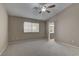 Spacious main bedroom with carpet, a ceiling fan, and a view of the ensuite bathroom at 8121 Heavenly Star Cir, Las Vegas, NV 89128