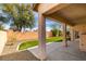 A covered back patio with synthetic grass and desert landscaping creates a peaceful outdoor living space at 8232 Sedona Sunset Dr, Las Vegas, NV 89128