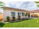 Spacious backyard with low-maintenance synthetic grass and desert plants, creating a private outdoor retreat at 8232 Sedona Sunset Dr, Las Vegas, NV 89128