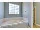 Bathroom features a large tub and a glass block window at 8232 Sedona Sunset Dr, Las Vegas, NV 89128