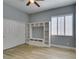 Bedroom with wood flooring, built-in shelving, closet, and shuttered window at 8232 Sedona Sunset Dr, Las Vegas, NV 89128
