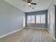 Bedroom features wood floor, neutral paint, ceiling fan, and shuttered windows at 8232 Sedona Sunset Dr, Las Vegas, NV 89128