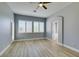Bedroom features wood floor, neutral paint, ceiling fan, and shuttered windows at 8232 Sedona Sunset Dr, Las Vegas, NV 89128