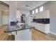 Bright modern kitchen with a large island, granite countertops, and white cabinets at 8232 Sedona Sunset Dr, Las Vegas, NV 89128