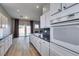 Bright kitchen features white cabinetry, granite countertops, stainless steel appliances, and access to the backyard at 8232 Sedona Sunset Dr, Las Vegas, NV 89128