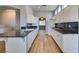 Modern kitchen with granite countertops, white cabinetry, and wood floors at 8232 Sedona Sunset Dr, Las Vegas, NV 89128
