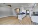 Spacious living room adjacent to kitchen with wood floors and neutral paint at 8232 Sedona Sunset Dr, Las Vegas, NV 89128