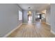 Bright living room with wood floors that connects to the dining and Gathering rooms through arched doorways at 8232 Sedona Sunset Dr, Las Vegas, NV 89128