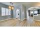 Bright living room featuring modern light fixtures, wood floors and an open floor plan at 8232 Sedona Sunset Dr, Las Vegas, NV 89128