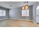 Bright living room featuring modern light fixtures, wood floors and large windows at 8232 Sedona Sunset Dr, Las Vegas, NV 89128