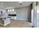 Open floorplan living room with wood floors, granite counters, white cabinets at 8232 Sedona Sunset Dr, Las Vegas, NV 89128