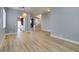 Open-concept living room features wood-look flooring, neutral paint, and decorative lighting fixtures at 8232 Sedona Sunset Dr, Las Vegas, NV 89128