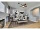 Comfortable living room with light wood floors, neutral walls, fireplace, and modern decor at 8232 Sedona Sunset Dr, Las Vegas, NV 89128