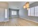 Bright living room featuring modern light fixtures, wood floors, and plenty of natural light at 8232 Sedona Sunset Dr, Las Vegas, NV 89128