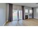 Open living room with fireplace, wood floors, and sliding glass doors at 8232 Sedona Sunset Dr, Las Vegas, NV 89128