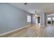 Bright living room with wood floors that connects to the dining and Gathering rooms through arched doorways at 8232 Sedona Sunset Dr, Las Vegas, NV 89128