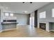 Open living space featuring a fireplace, access to the kitchen and dining areas at 8232 Sedona Sunset Dr, Las Vegas, NV 89128