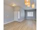 Bright living room featuring modern light fixtures, wood floors, and a white front door at 8232 Sedona Sunset Dr, Las Vegas, NV 89128