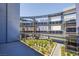 Attractive apartment balcony with glass railings, grass, and plants at 8925 W Flamingo Rd # 228, Las Vegas, NV 89147