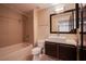 Cozy bathroom with a shower over tub, single sink vanity, and a sleek framed mirror at 8925 W Flamingo Rd # 228, Las Vegas, NV 89147