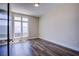 Neutral bedroom featuring a large window for natural light and durable wood flooring at 8925 W Flamingo Rd # 228, Las Vegas, NV 89147