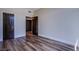 Inviting bedroom with wood-look flooring and neutral walls, featuring dark-stained doors and trim at 8925 W Flamingo Rd # 228, Las Vegas, NV 89147