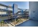 The building's modern exterior features stairs, a metal roof, landscaping, and a blue accent color at 8925 W Flamingo Rd # 228, Las Vegas, NV 89147